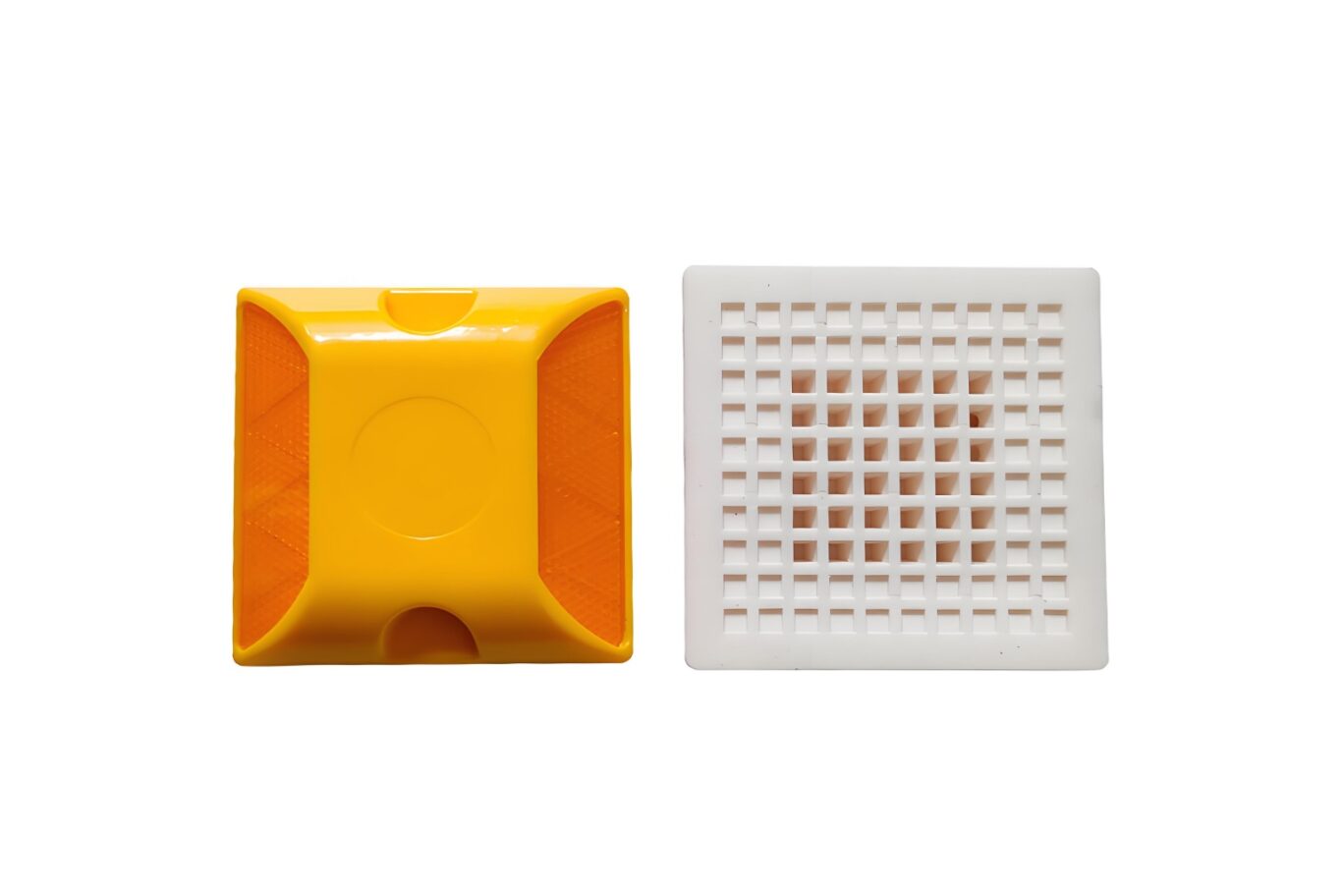 Yellow plastic reflective road stud with amber panels and white grid bottom base